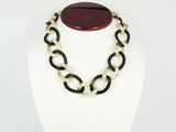 Chain Link Statement Necklace Classic necklace features a golden and black toned chain. Women. 5. Martinuzzi Accessories.