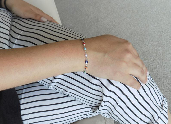Multicolor evil eye bracelet worn on wrist showing size and fit