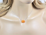 Opal pumpkin necklace displayed on a mannequin, showing how the chain sits when worn.