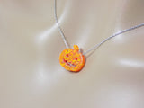 Opal pumpkin necklace displayed on a mannequin, showing how the chain sits when worn.