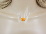Opal pumpkin necklace displayed on a mannequin, showing how the chain sits when worn.